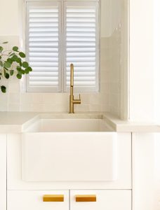 Kitchen renovation small apartment interior design and decoration. Custom designed white kitchen joinery with white marble and white handmade splash back tile designed by ACP Studio Interior Design in Coogee, Sydney.