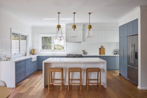 Seaforth house renovation interior design and decoration with custom designed kitchen, blue joinery and white marble bench top designed by ACP Studio Interior Design in Seaforth, Sydney.