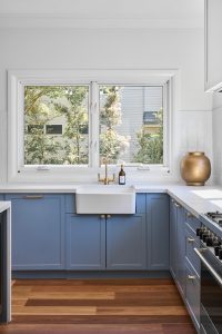 Seaforth house renovation interior design and decoration with custom designed kitchen, blue joinery and white marble bench top designed by ACP Studio Interior Design in Seaforth, Sydney.