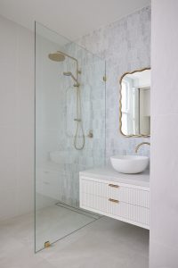 Bathroom renovation interior design, carrara marble mosaic wall tile, custom made vanity and brass tap ware designed by ACP Studio Interior Design in Forest Lodge, Sydney.