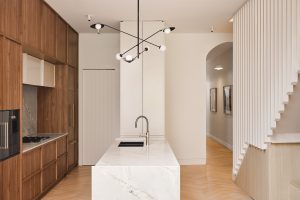 Kitchen renovation, custom designed walnut veneer kitchen with marble splash back and wall ovens designed by ACP Studio Interior Design in Coogee, Sydney.