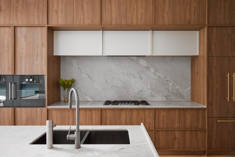 Kitchen renovation, custom designed walnut veneer kitchen with marble splash back and wall ovens designed by ACP Studio Interior Design in Coogee, Sydney.