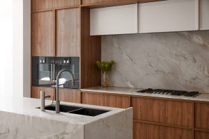 Kitchen renovation, custom designed walnut veneer kitchen with marble splash back and wall ovens designed by ACP Studio Interior Design in Coogee, Sydney.
