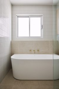 Bathroom renovation, clean and fresh coastal home neutral tiles with freestanding bath designed by ACP Studio Interior Design in Balgowlah Heights, Sydney.