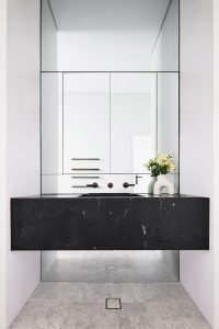 Bathroom renovation black marble vanity with mirrored wall and marble floor tiles designed by ACP Studio Interior Design in Vaucluse, Sydney.