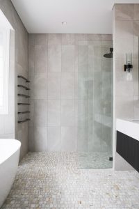 Bathroom renovation with marble mosaic floor tiles, freestanding bath, walk in shower, custom vanity and wall lights designed by ACP Studio Interior Design in Vaucluse, Sydney.